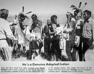 He's a Genuine Adopted Indian: Allen Old Horn (third from right) presents actor Dustin Hoffman with a buck's costume as the 'Little Big Man' star becomes a member of the Crow tribe. Behind the actor is his adopted mother, May Childs Old Coyote. At left, Duane Old Horn shows Mrs. Hoffman and her daughter a buckskin shawl. Gazette photo by Bill Tutokey.